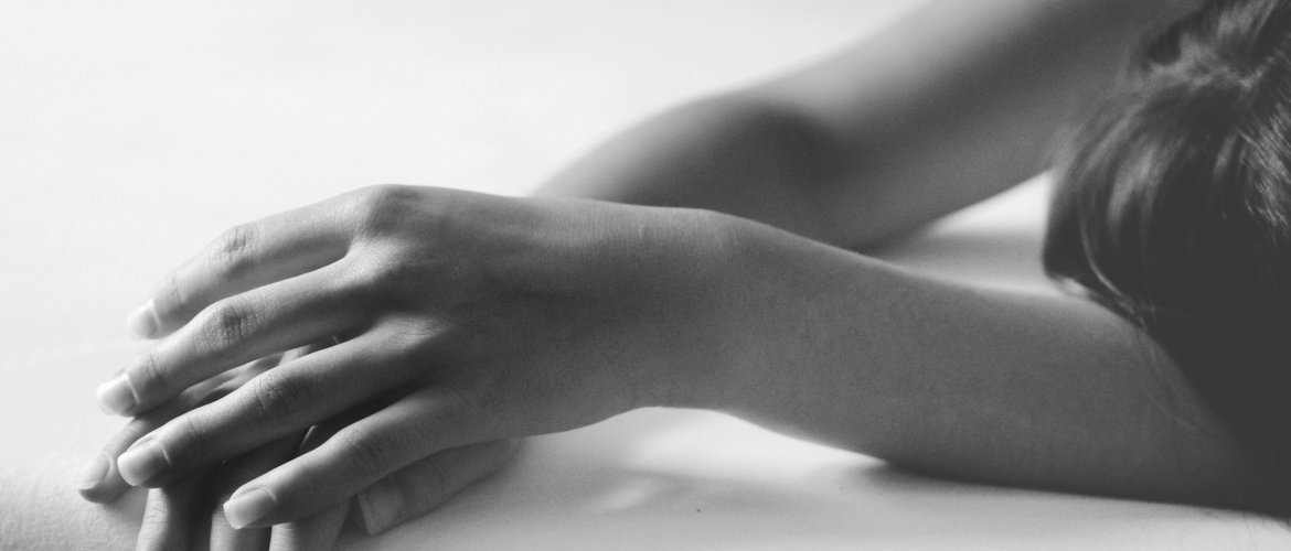 Foto em preto e branco de mulher deitada, com endometrite crônica